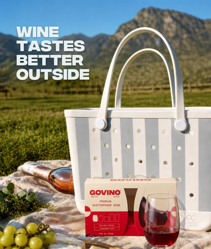 Wine tastes better outside — Govino x Clauds & Cands glacier grey stripe tote with shatterproof wine glasses at a vineyard picnic