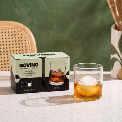 Govino Rocks gift box beside a whisky glass with ice sphere