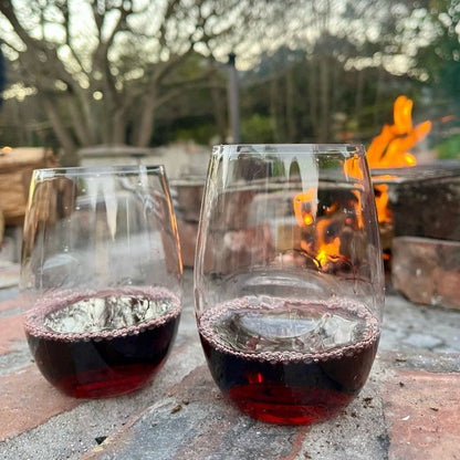 Govino Wine Lovers — two shatterproof wine glasses with red wine by an outdoor fire pit